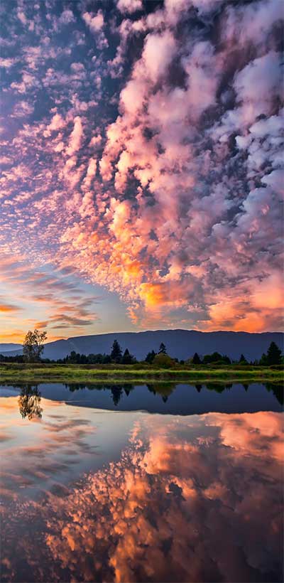 Clouds and lake reflection at sunset